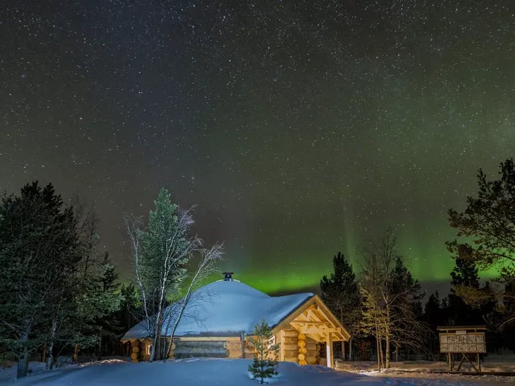 Traditional Scandinavian BBQ hut under the Northern Lights