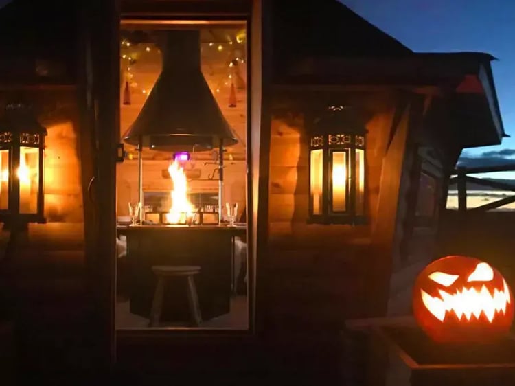 Arctic Cabin at Halloween, with pumpkins outside