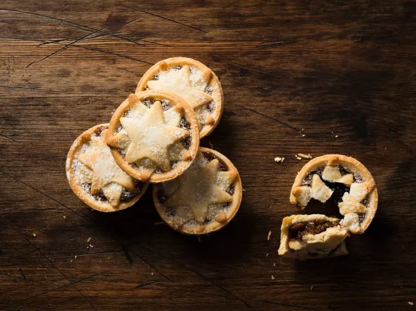 homemade mince pies on wooden chopping board 