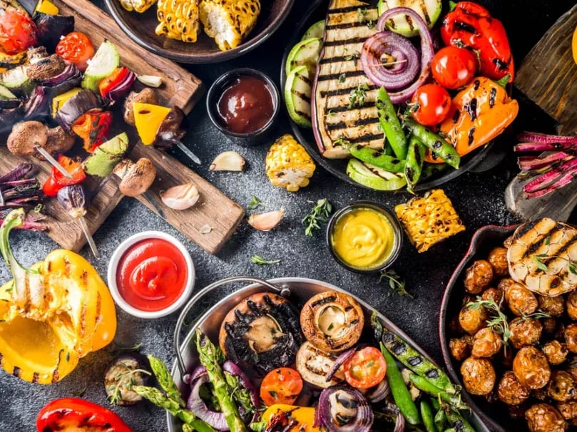 Selection of BBQ food and ingredients on a wooden chopping board