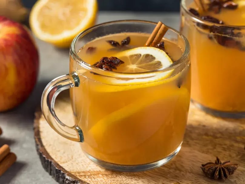 mulled cider in glass with cinnamon sticks and star anise