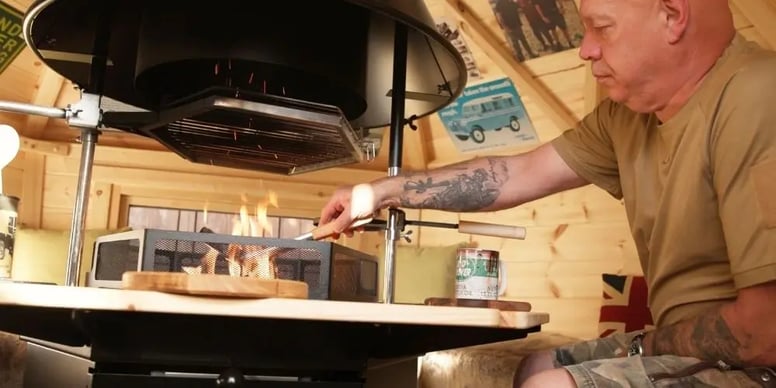 Interior of Arctic Cabin Grill Hut with BBQ lit and kebabs cooking over the heat