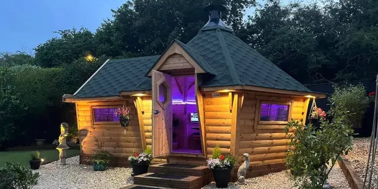 bbq cabin bar lit up at dusk