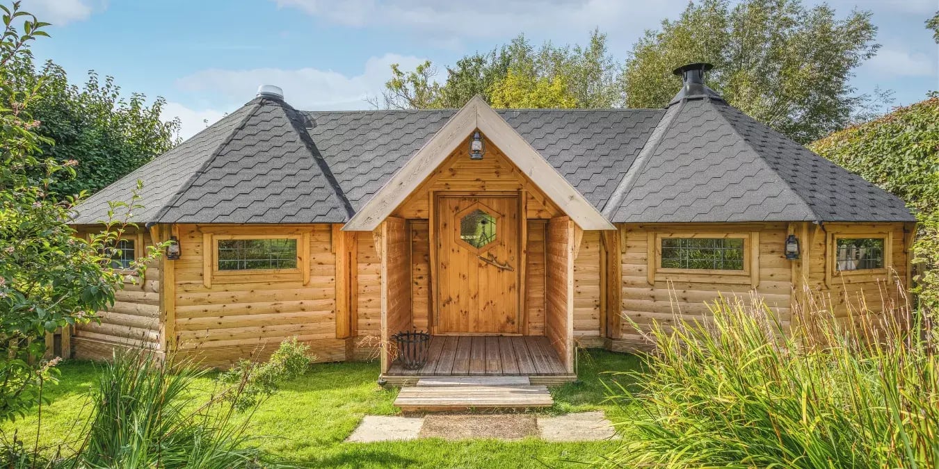 Two 17m2 log cabins joined together with a straight cabin in the centre.