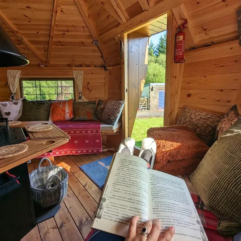 person reading inside bbq cabin