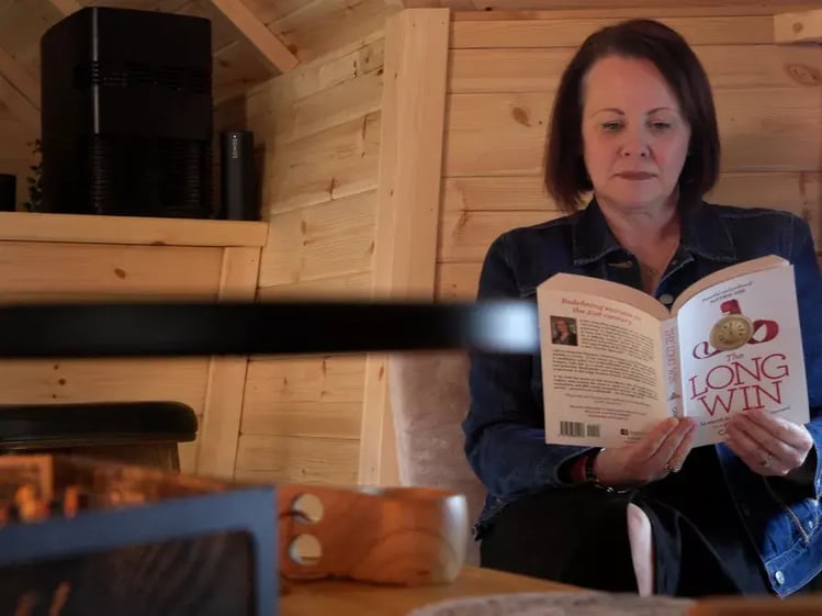 lady reading book inside arctic cabin