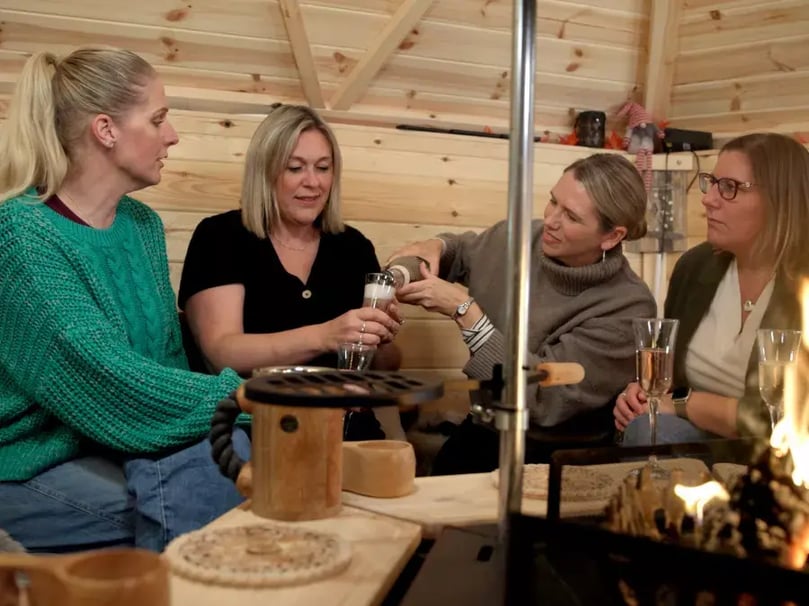 Group  of women enjoying drinks inside an Arctic Cabins garden bar
