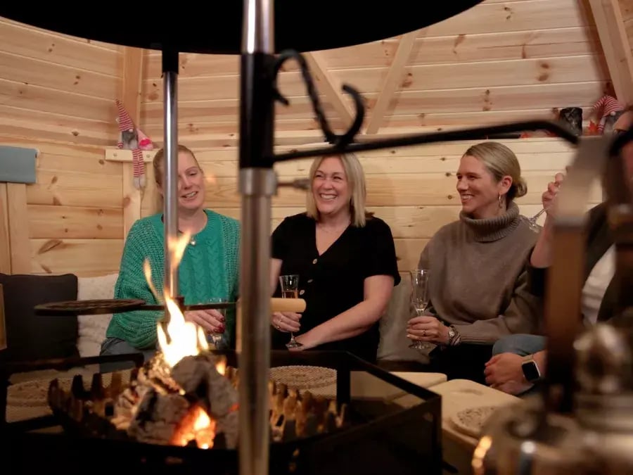 friends laughing inside bbq cabin