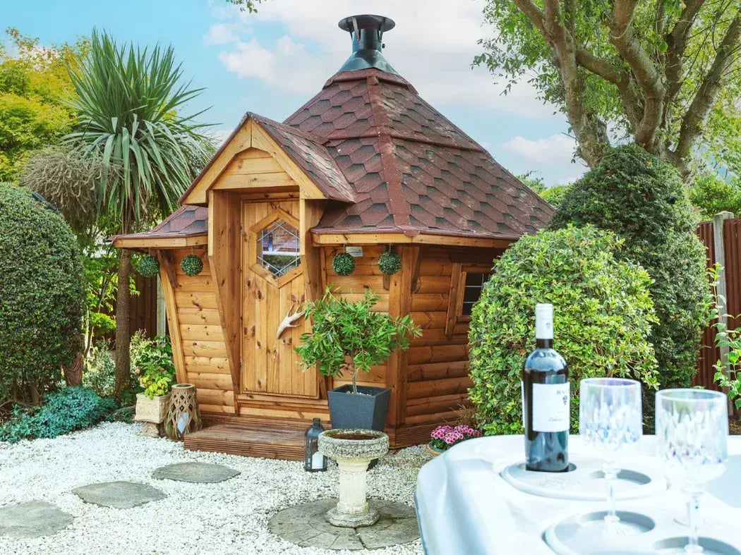 scandinavian barbecue hut in garden with hot tub 
