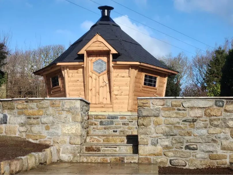 10m² Arctic Cabins BBQ House with black roof, in garden