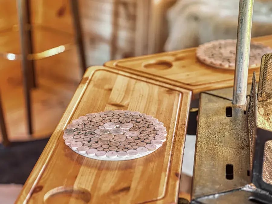 close up of timber tray tables around bbq fire pit