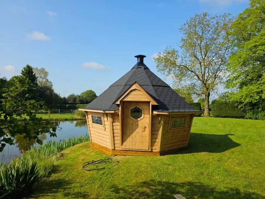 Grill Shack next to a lake in a green grass field