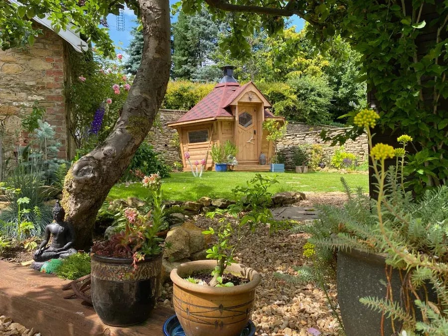 Scandinavian bbq hut in garden with red roof