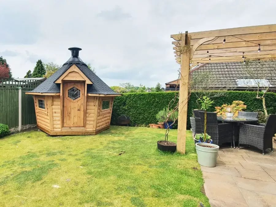 bbq house in the corner of a small garden 