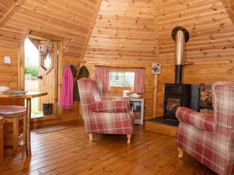 Inside a Arctic Cabins BBQ House with log burner lit