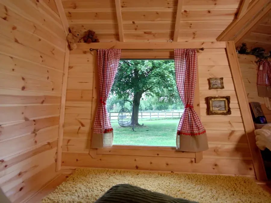 view into the garden from a log cabin