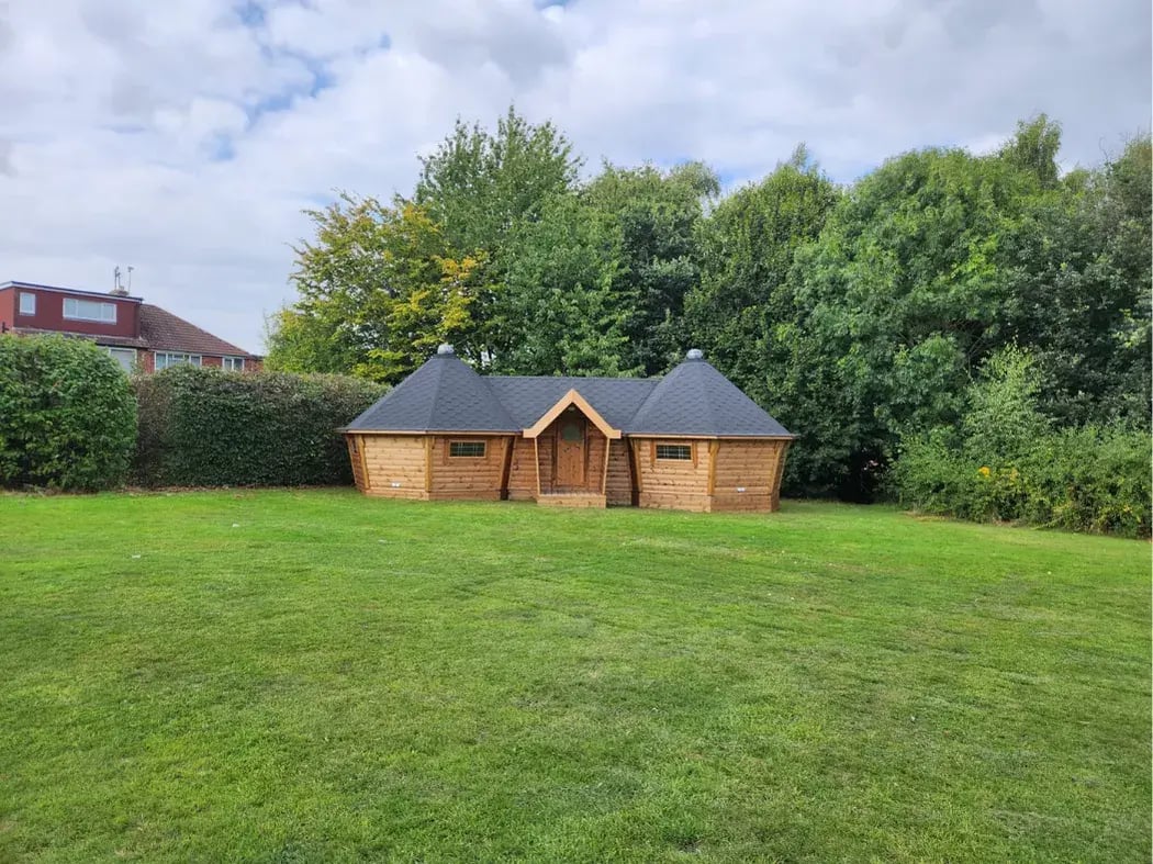 Wooden linked barbecue huts UK with cosy entertaining and dining space