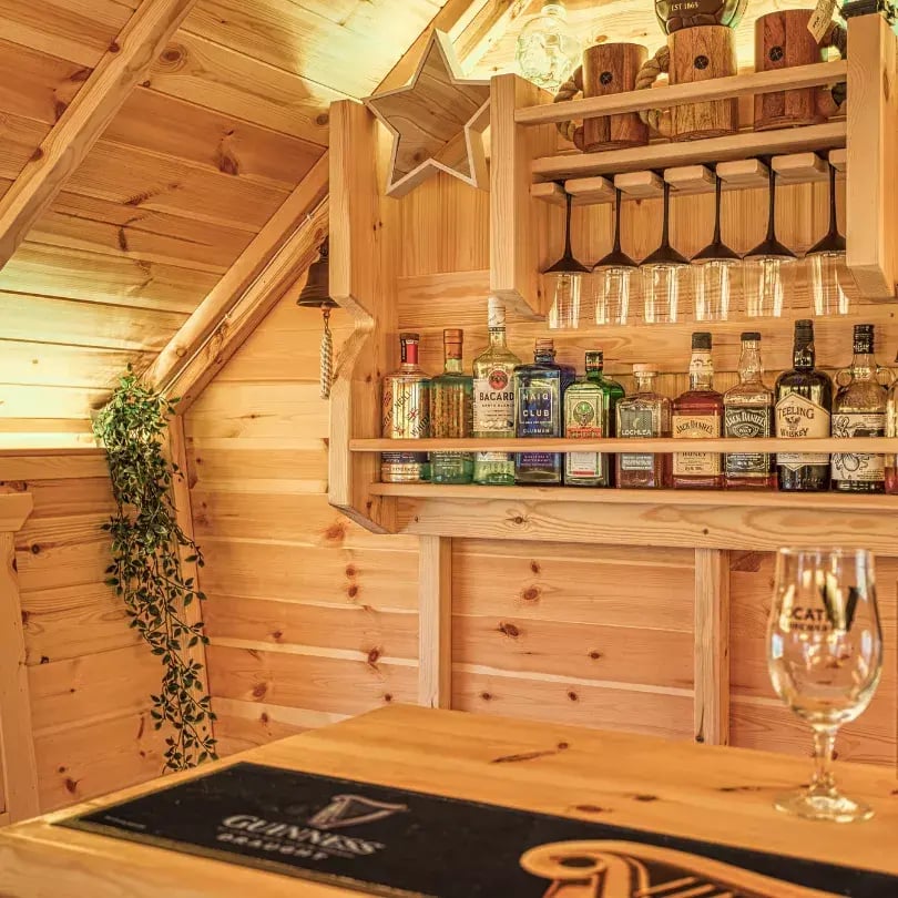 fire lit inside a garden pub with drinks rck
