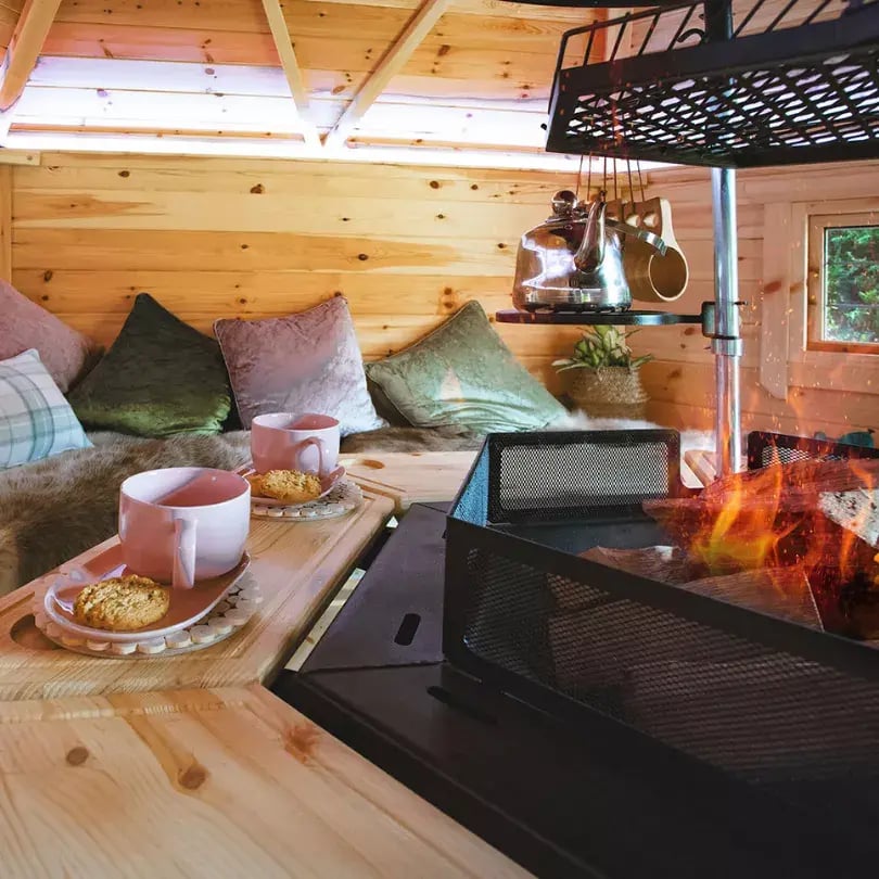 The central grill and tables in a 10m2 Arctic Cabins BBQ cabin with hot drinks and cookies.