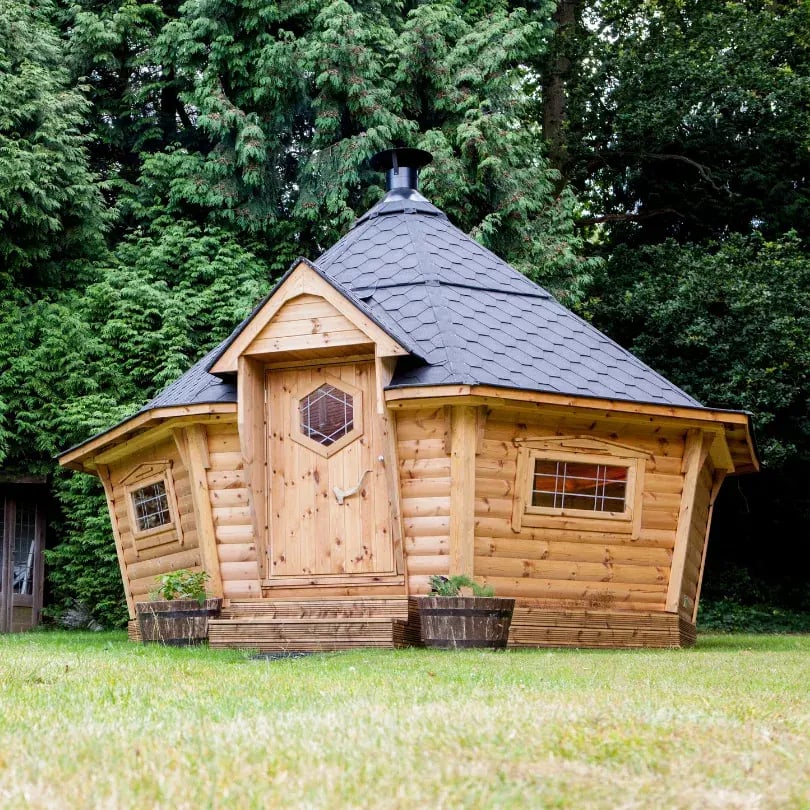 Large BBQ grill house in a garden.