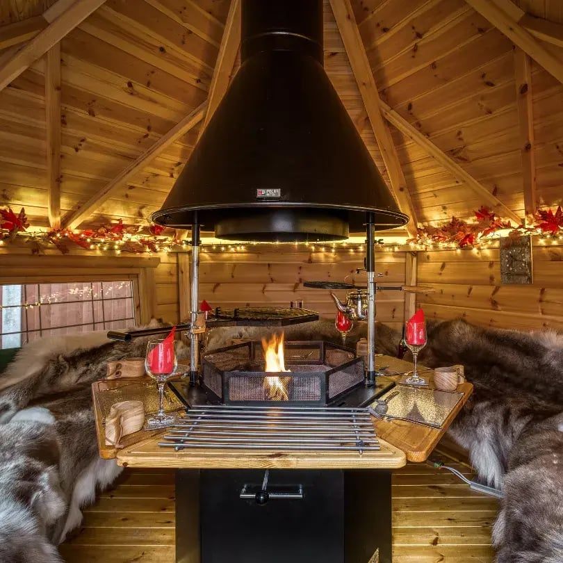 A small BBQ hut decorated with fairy lights and faux red leaves.