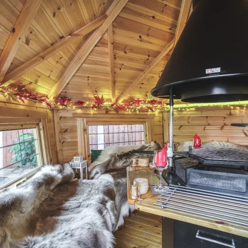 reindeer skin blankets on benches inside an arctic cabin