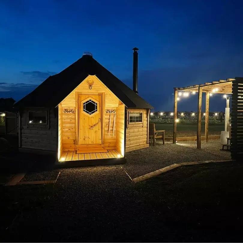 timber camping cabin at night
