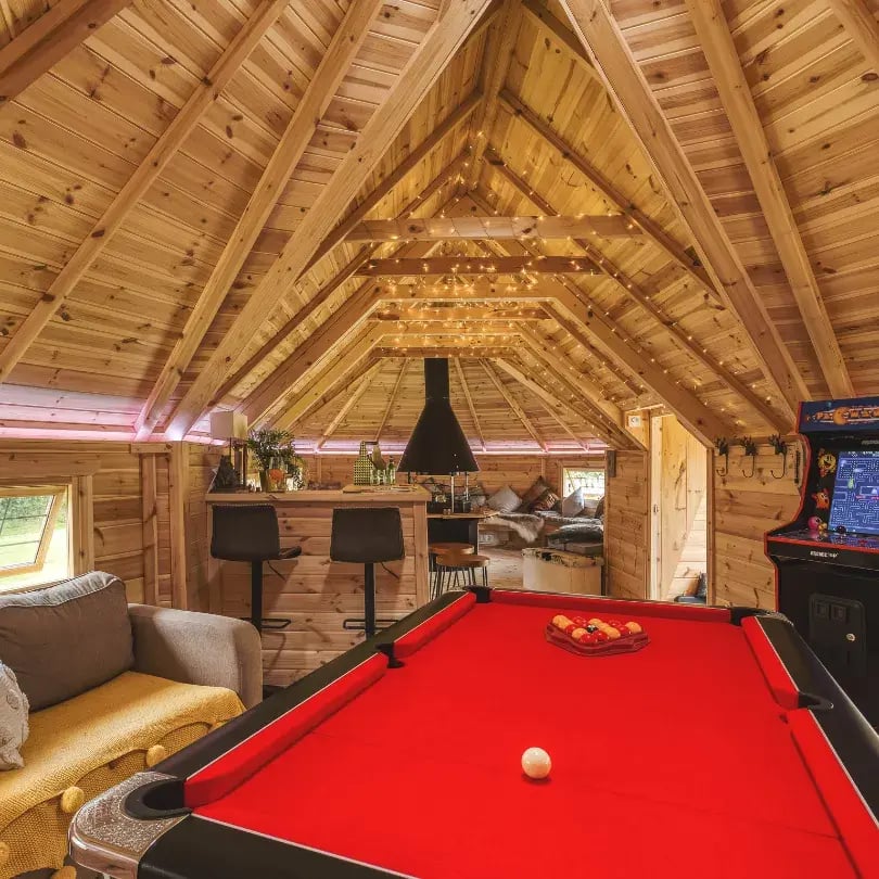 Linked cabins with a BBQ, bar and pool table.
