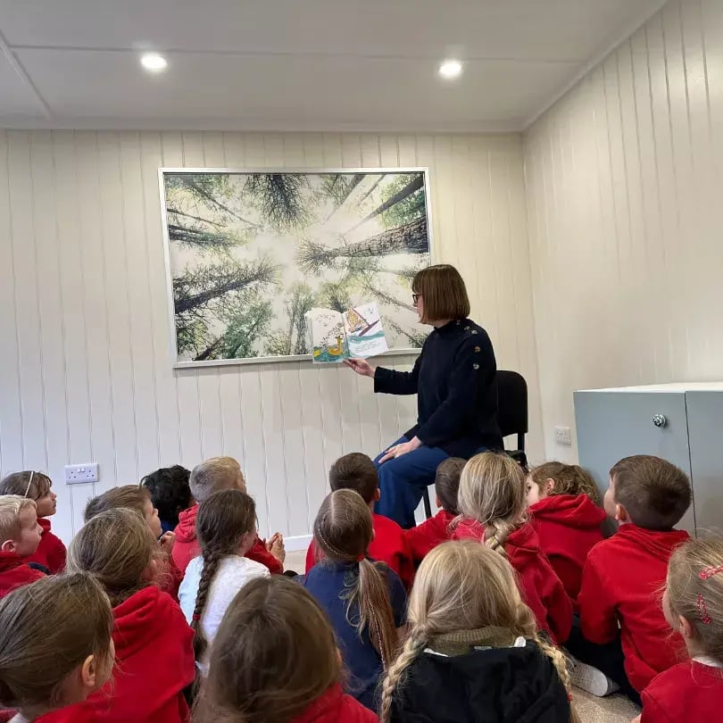 teacher leading lesson inside a school cabin building