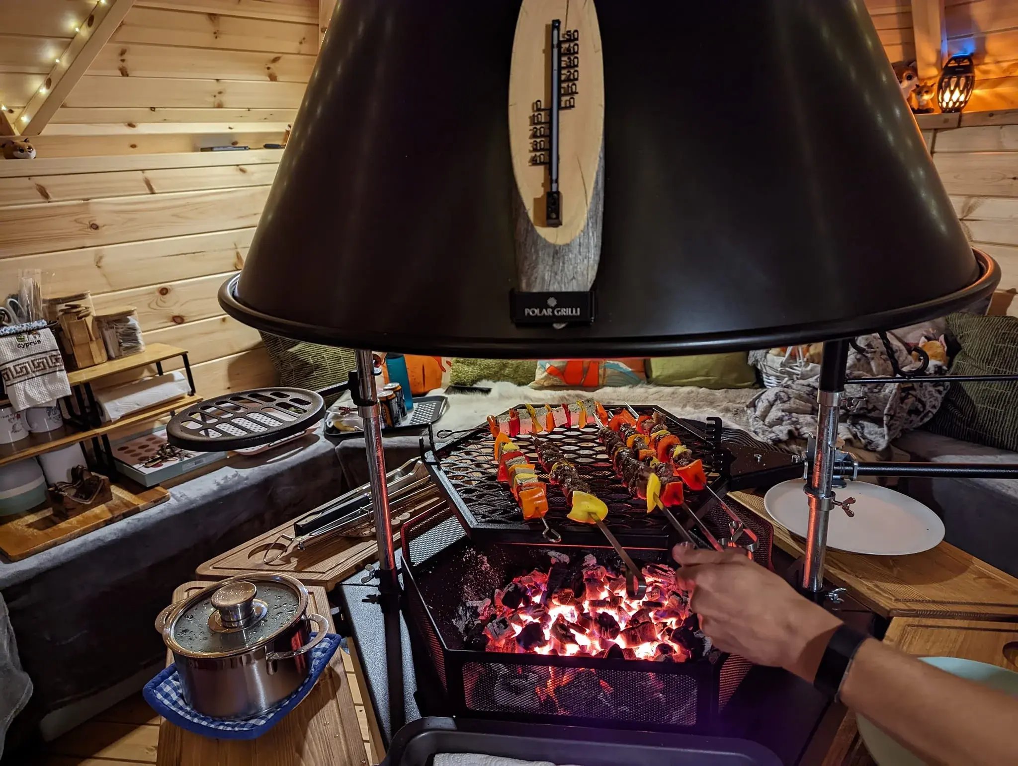A mix of lamb and vegan tofu skewers being cooked in a grill hut.