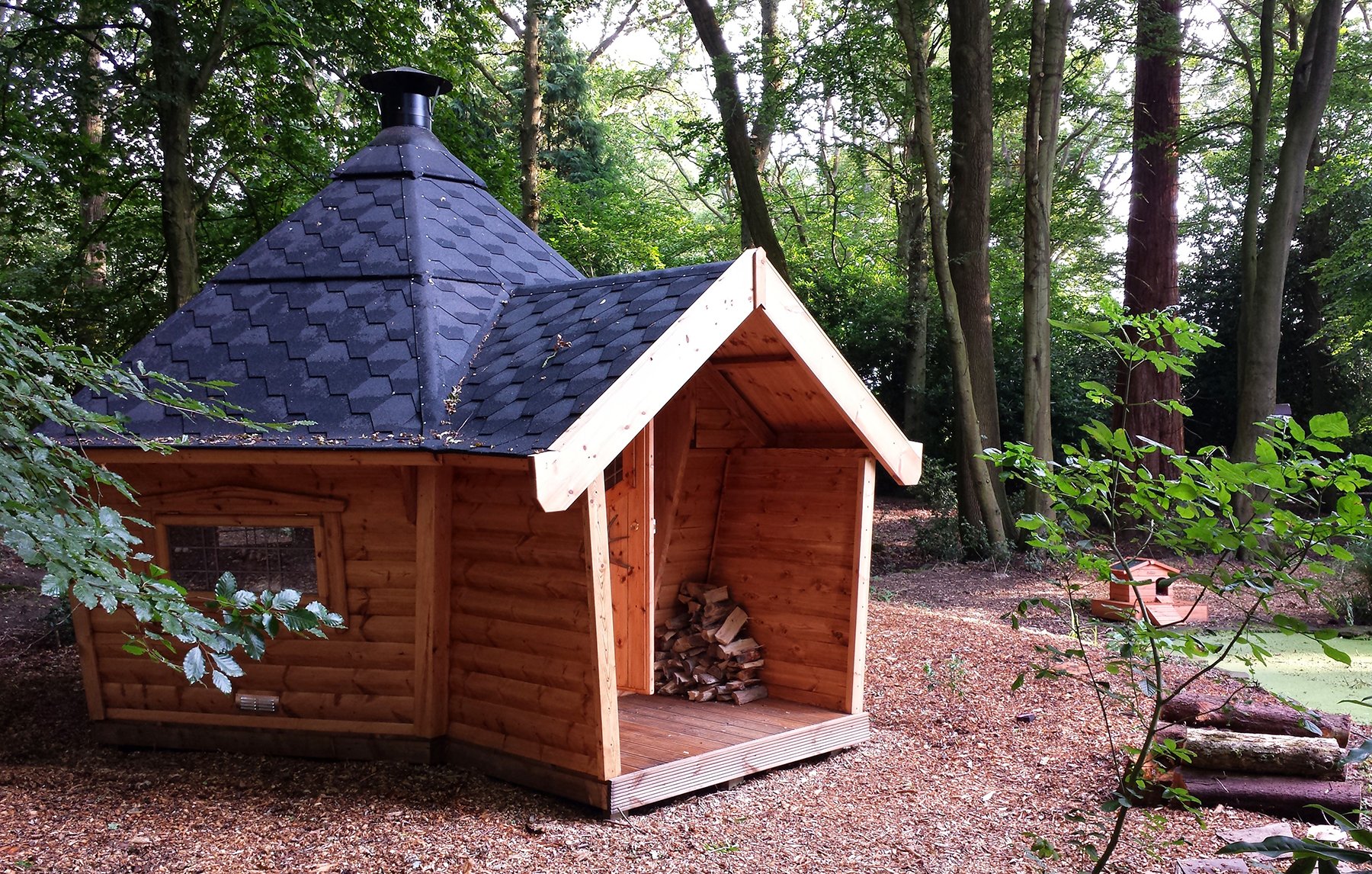 Arctic Cabin Grill Shack with porch in wooded area