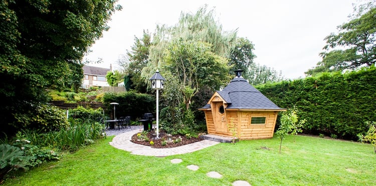Exterior photo of a BBQ cabin with black roof