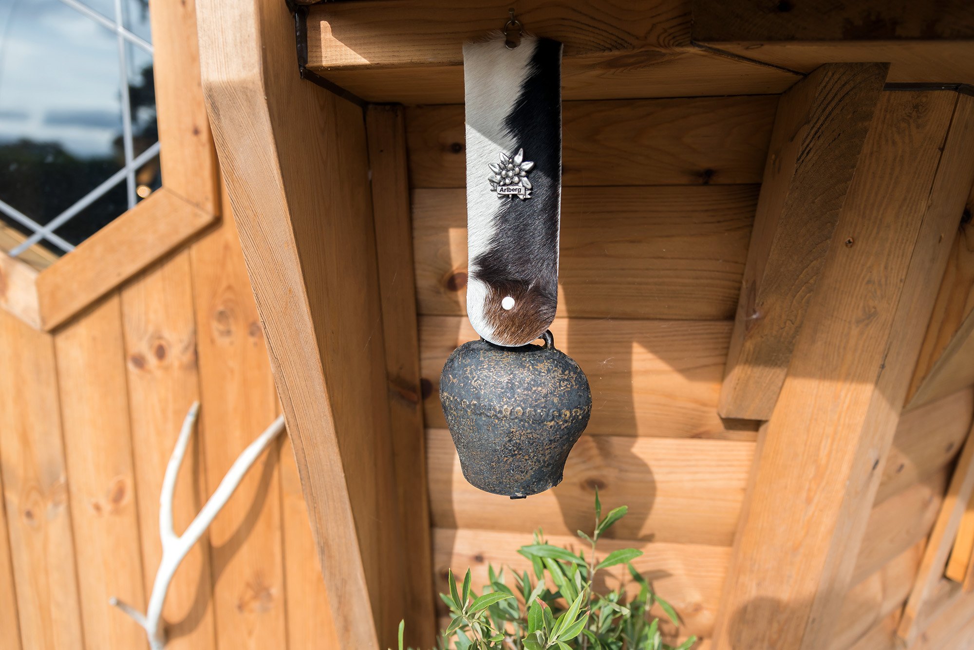 Close up of the exterior of an Arctic Cabin timber BBQ cabin with hanging cowbell