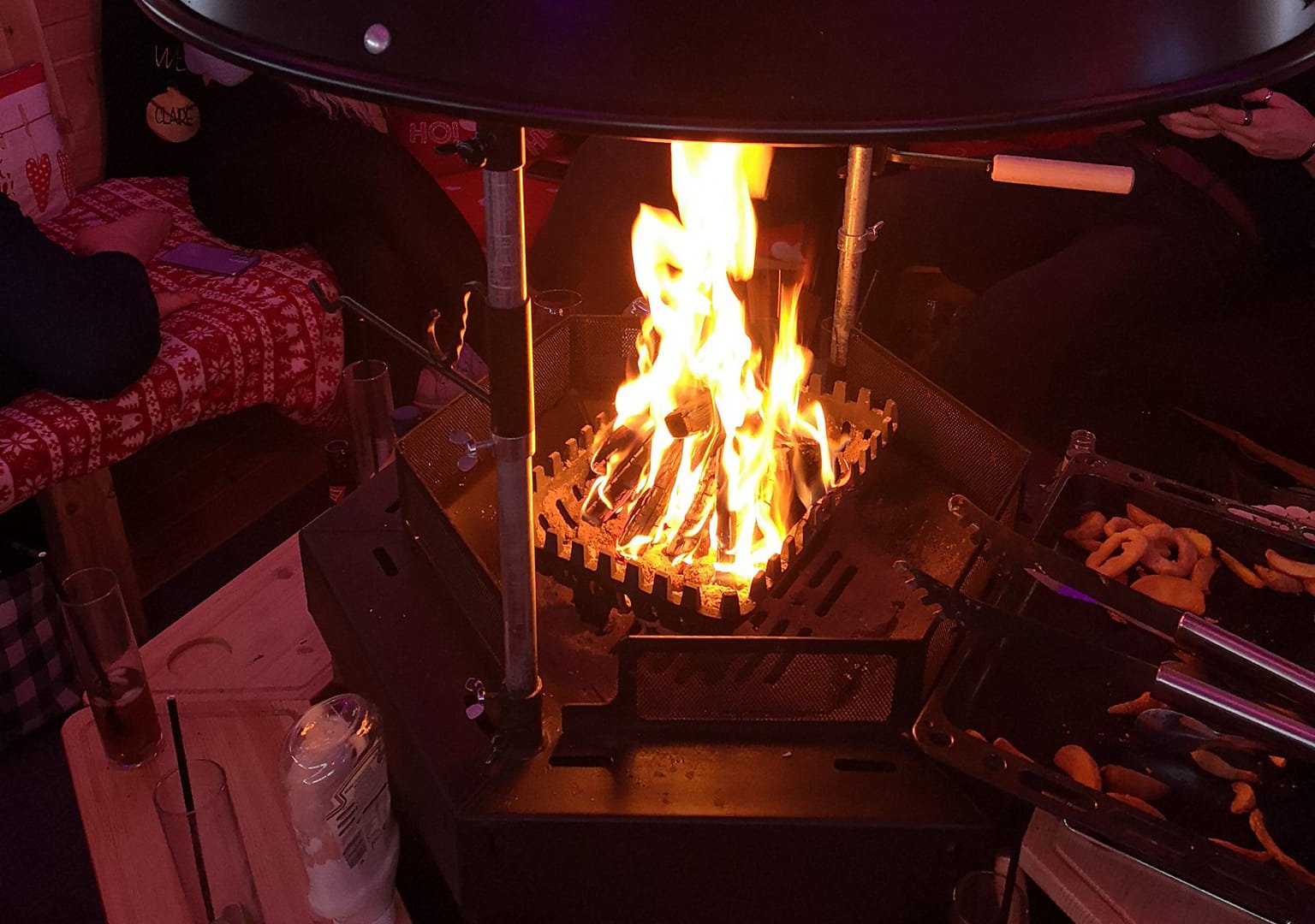 Image of an Arctic Cabin BBQ lit with fire basket