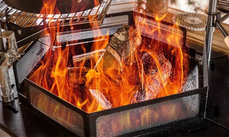fire burning inside arctic cabin BBQ hut