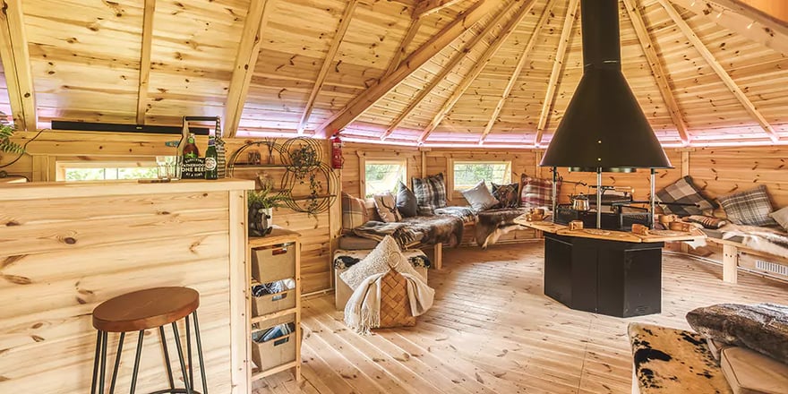View from the doorway of a connected cabin, looking towards the central bar and BBQ grill.