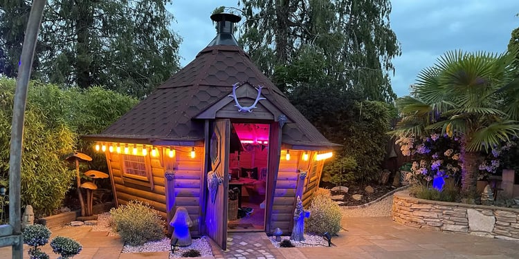 lit up bbq cabin at dusk