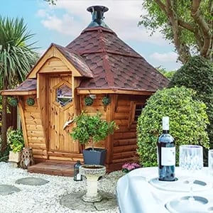 10m2 BBQ hut with a red roof next to a hot tub.