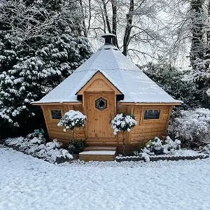 A large Scandinavian grilll hut in the snow