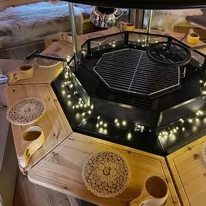 An indoor BBQ grill unit with fairy lights