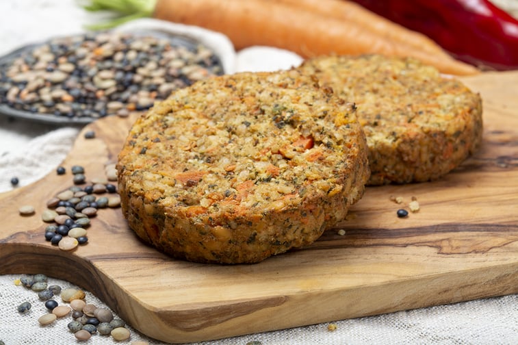 Vegan-friendly burgers on wooden chopping board