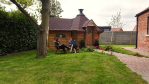 friends socialising outside large garden bar