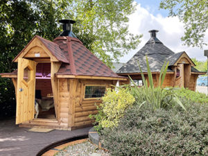 7m BBQ Hut with red roof, 10m Arctic Cabin with Black roof at the Nottingham Arctic Cabins Show Site