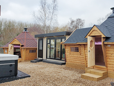 10m Garden Bar with black roof, 14m Arctic Bar with red roof at the Arctic Cabins Show Site in Studley