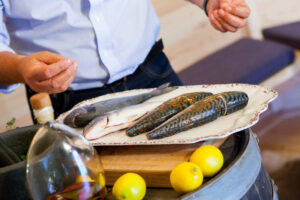 aldo zilli using his arctic cabins bbq cabin for cooking